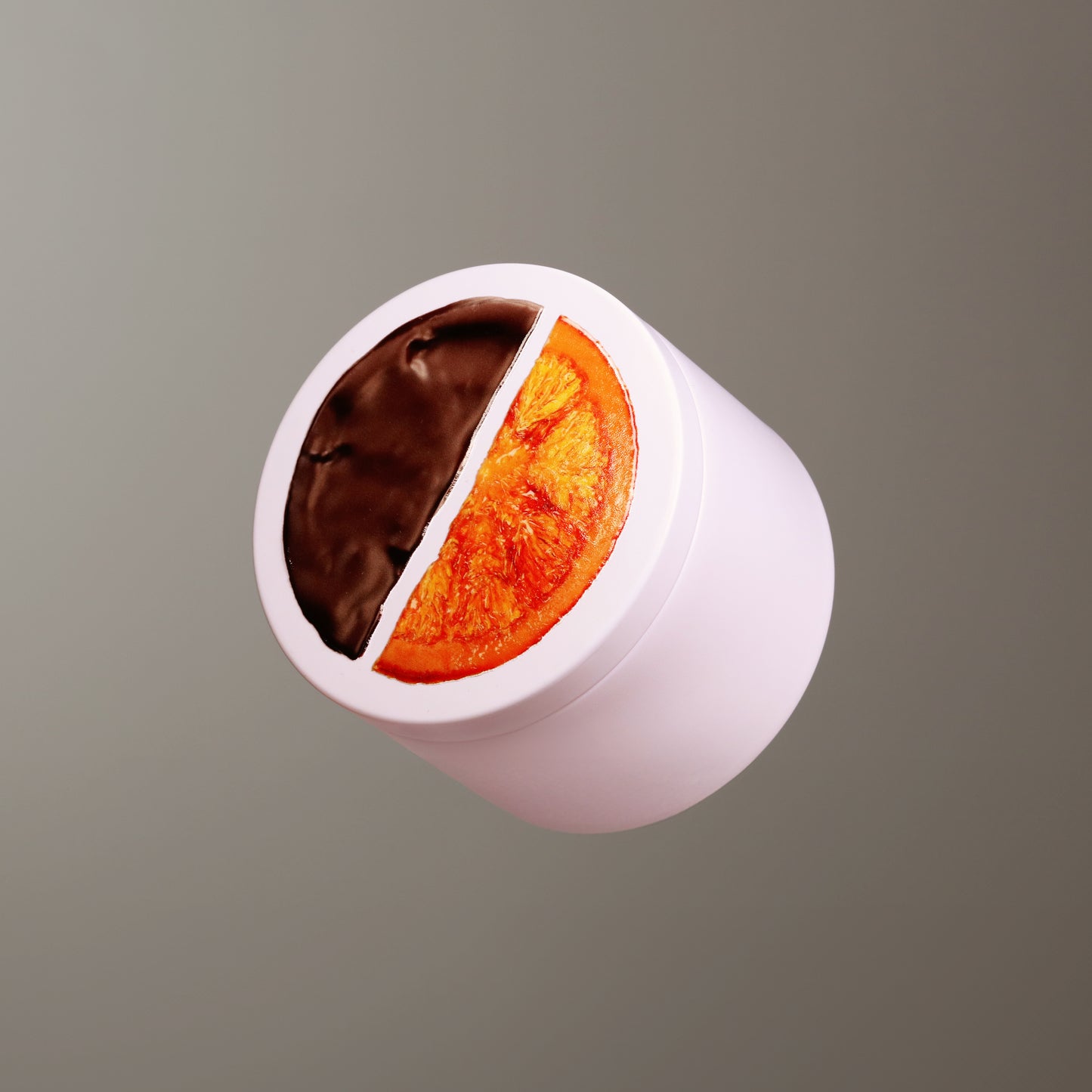 Cylindrical tin with white base and top, divided into chocolate and orange sections on a gray background