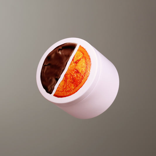 Cylindrical tin with white base and top, divided into chocolate and orange sections on a gray background