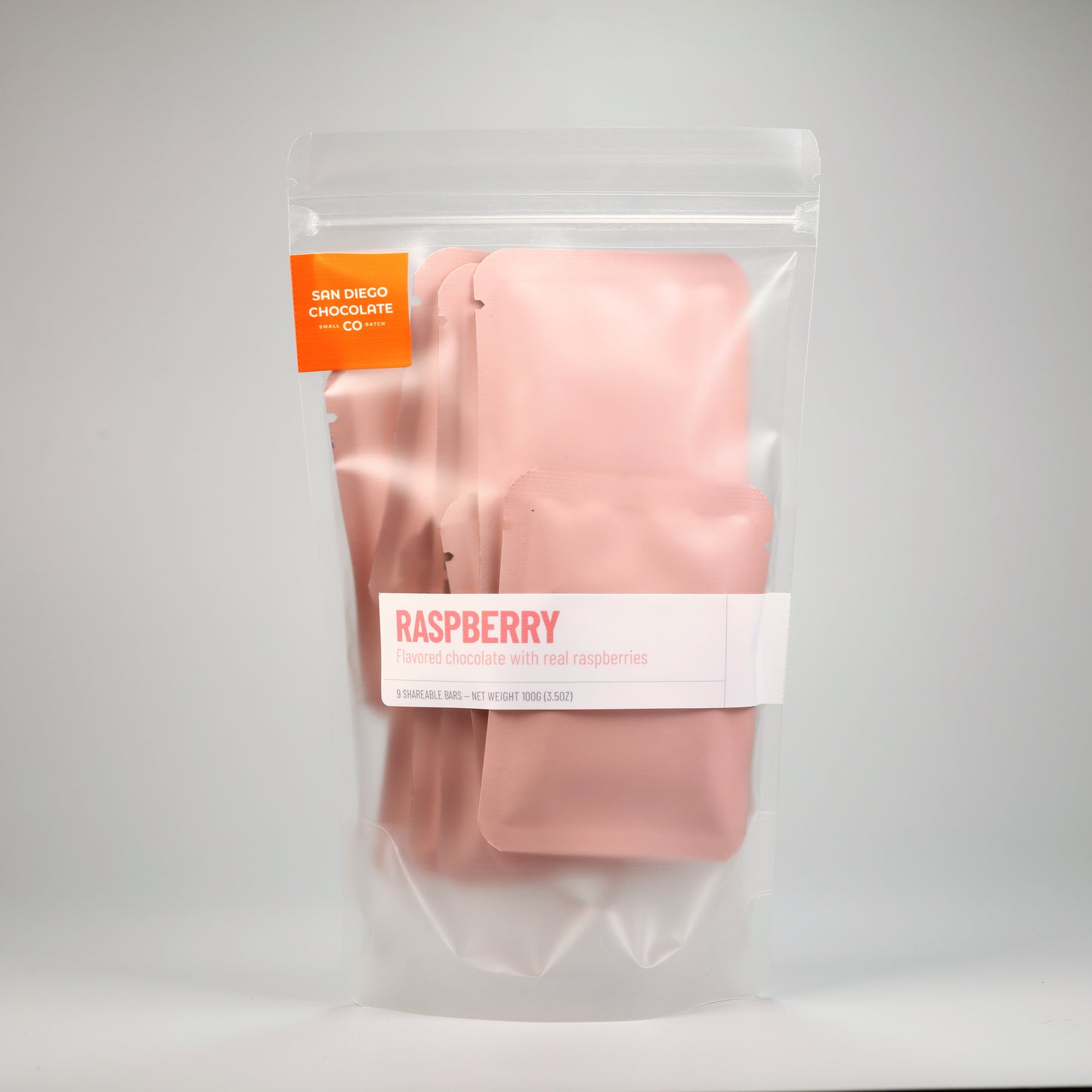 Packaged raspberry chocolate bars with San Diego Chocolate Co. branding on a gray background