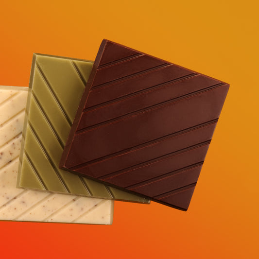 Dark, matcha and cookies and cream bars on gradient background